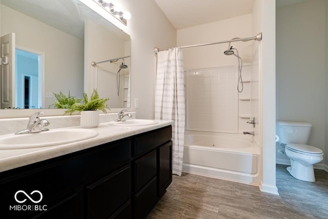 bathroom featuring shower / tub combo with curtain, a sink, toilet, and double vanity