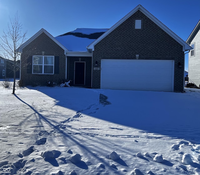 ranch-style home featuring a garage, brick siding, and driveway