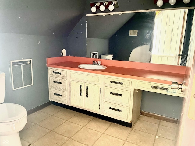600 N Meridian St, Brazil, IN 47834 - bathroom featuring toilet, vaulted ceiling, vanity, baseboards, and tile patterned floors