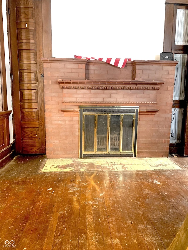 details with a brick fireplace and hardwood / wood-style floors