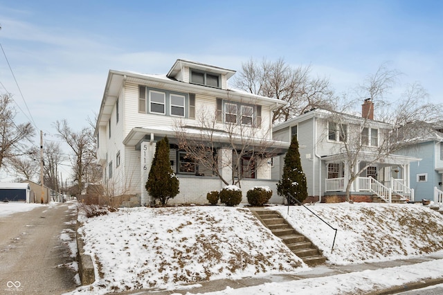 american foursquare style home with brick siding