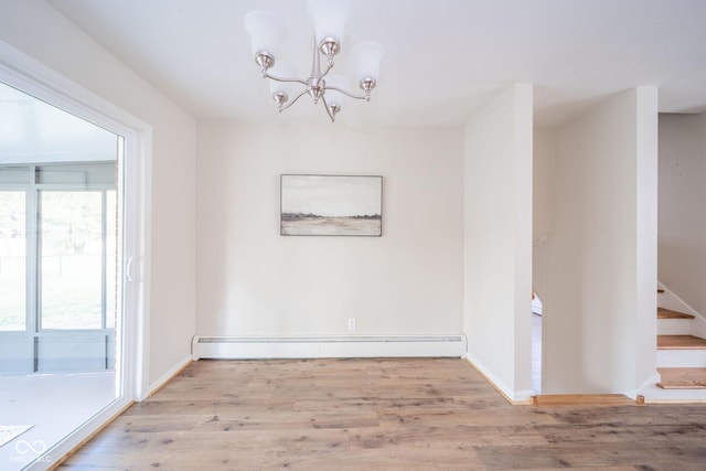 unfurnished dining area featuring light wood-type flooring, an inviting chandelier, stairs, and baseboard heating