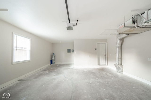 garage with baseboards, electric panel, and a garage door opener