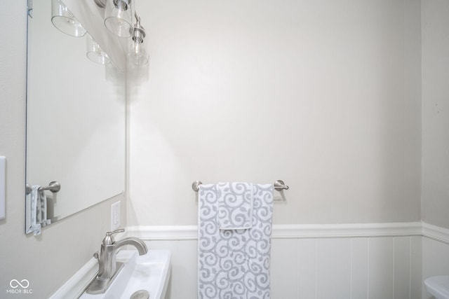 bathroom with toilet and wainscoting