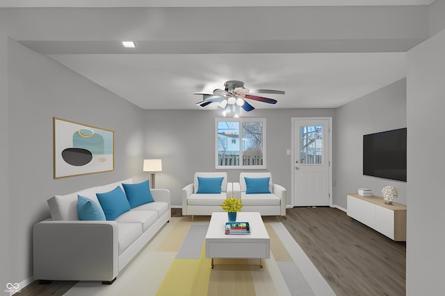 living room featuring light wood-type flooring, ceiling fan, and baseboards