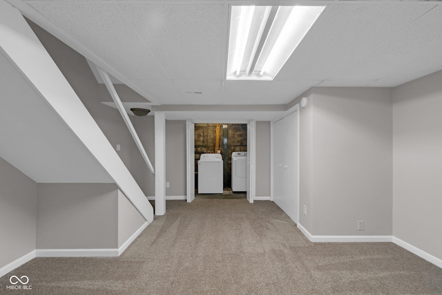 interior space featuring carpet floors, washer and dryer, stairway, and baseboards