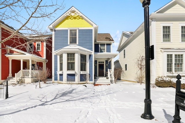 view of snow covered back of property