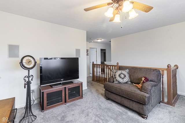 living room featuring baseboards, carpet, and ceiling fan