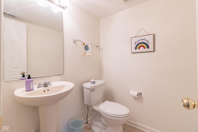 bathroom with visible vents, toilet, and baseboards