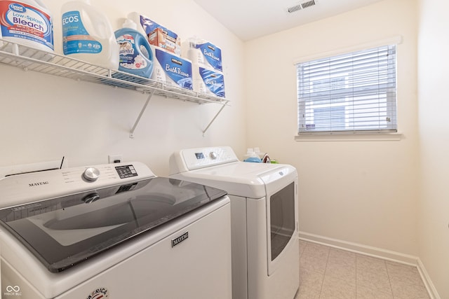 washroom with washer and dryer, laundry area, baseboards, and visible vents