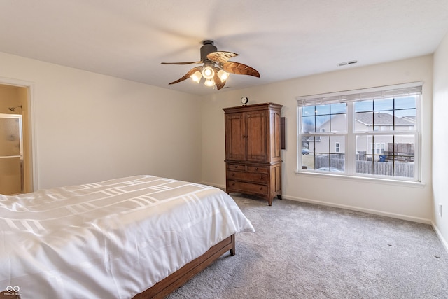 bedroom with visible vents, light colored carpet, baseboards, and ceiling fan