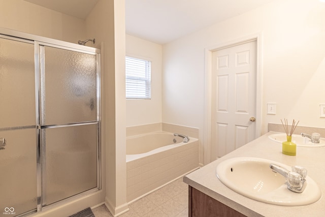 bathroom featuring a shower stall, a bath, double vanity, and a sink