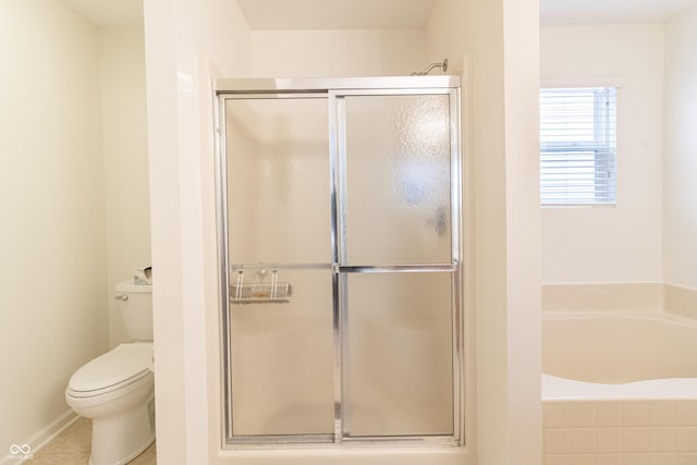 bathroom with tile patterned floors, a stall shower, toilet, and a garden tub