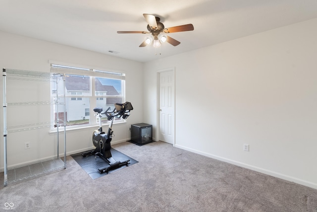 exercise area featuring carpet flooring, visible vents, baseboards, and ceiling fan