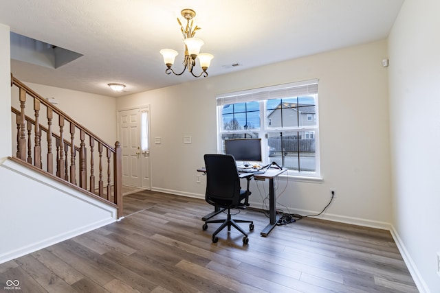 office featuring a notable chandelier, visible vents, baseboards, and wood finished floors