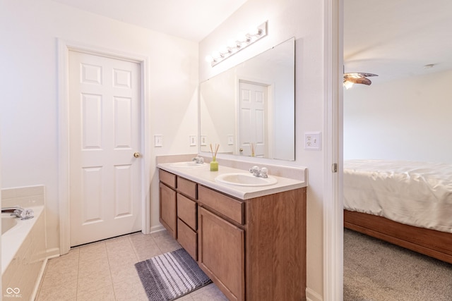 bathroom with double vanity, connected bathroom, tile patterned floors, and a sink