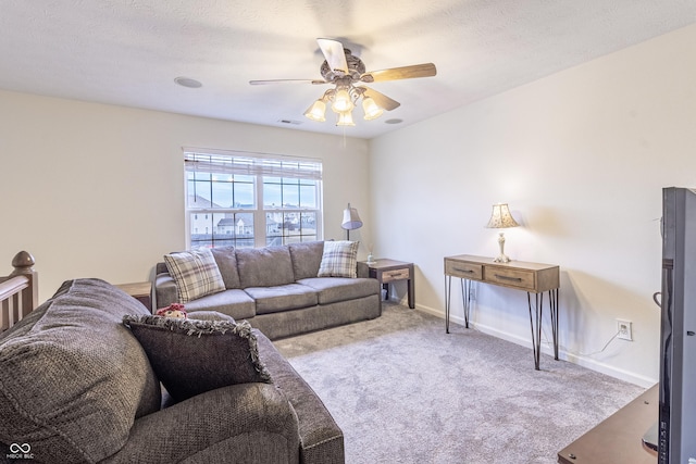 living room featuring visible vents, a textured ceiling, carpet floors, baseboards, and ceiling fan