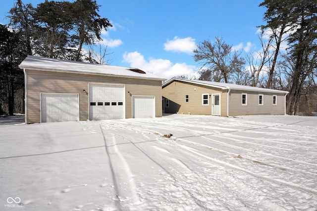 exterior space with a garage and an outbuilding