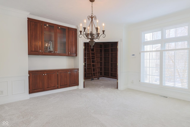 unfurnished dining area featuring light carpet, a decorative wall, and visible vents