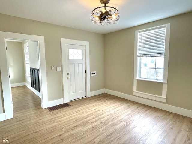 entrance foyer featuring baseboards, visible vents, and light wood finished floors