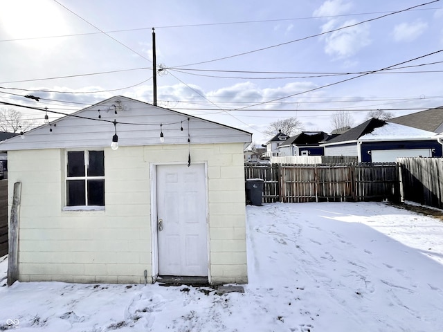 snow covered structure featuring fence