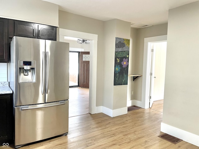 kitchen featuring baseboards, light wood-style flooring, visible vents, and stainless steel fridge with ice dispenser