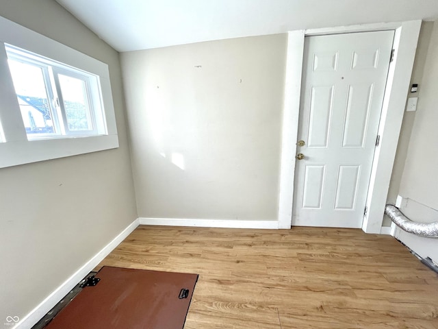 spare room with light wood-style flooring and baseboards