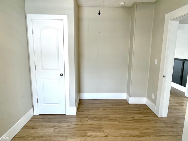 interior space featuring light wood-style flooring and baseboards