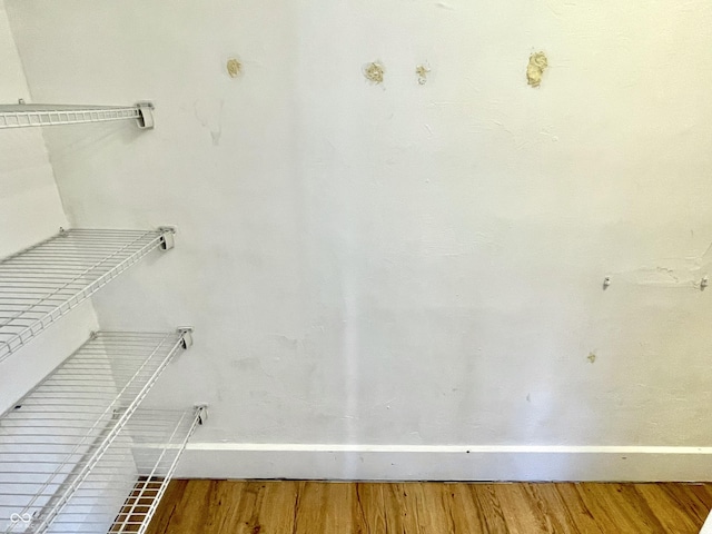 walk in closet featuring wood finished floors