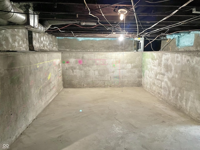 unfinished basement featuring electric panel