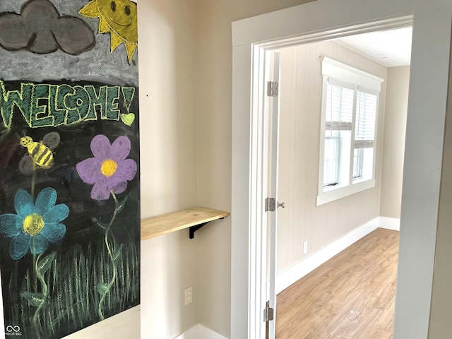 bathroom with baseboards and wood finished floors