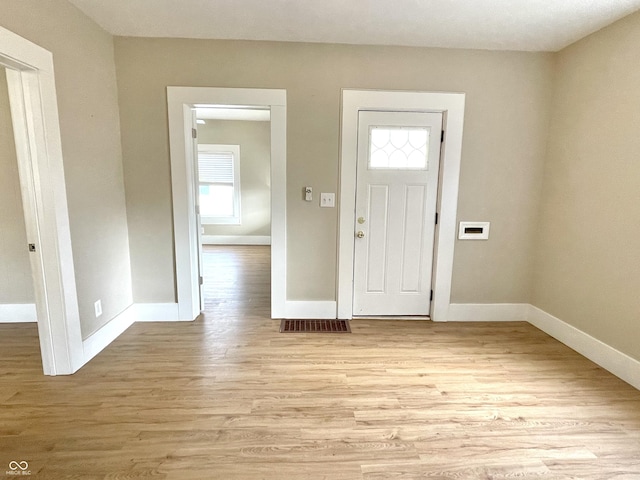 entrance foyer featuring baseboards, visible vents, and light wood-style floors