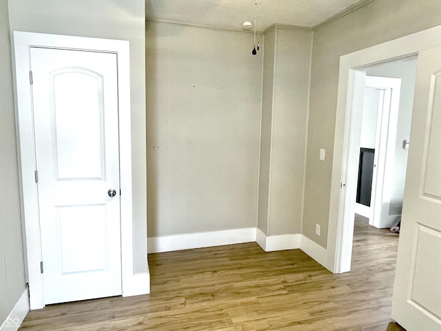 spare room with light wood-style flooring and baseboards