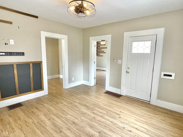 entrance foyer featuring light wood-type flooring, baseboards, and visible vents