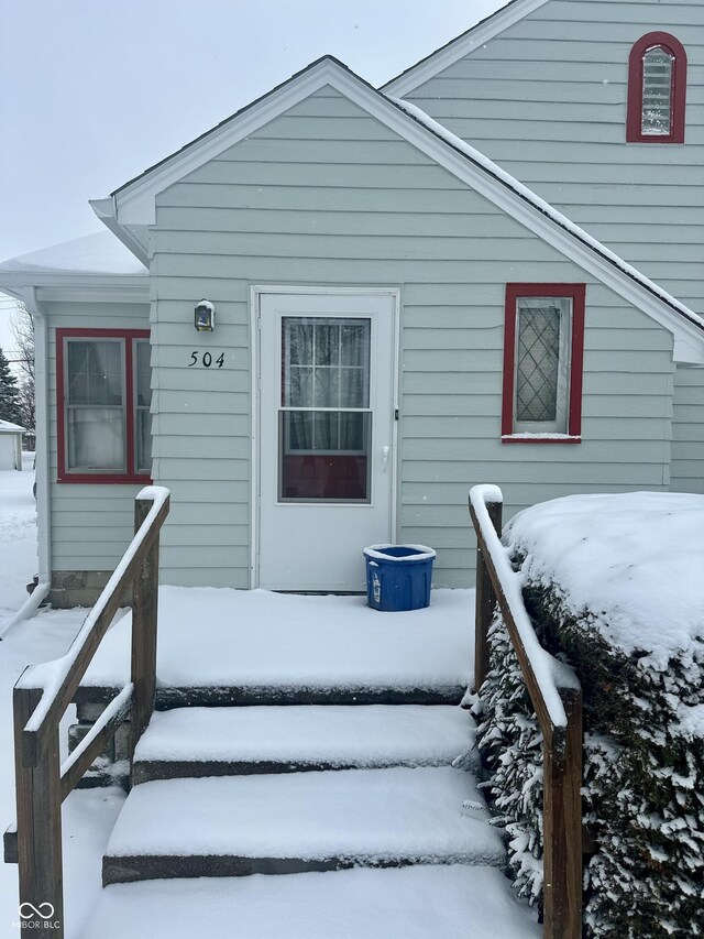 view of snow covered property entrance