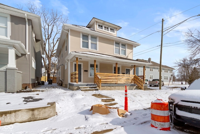 american foursquare style home with covered porch