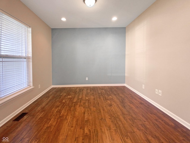 empty room with dark hardwood / wood-style flooring