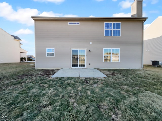 back of property with a patio, cooling unit, and a yard