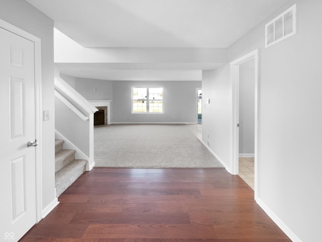 corridor with dark hardwood / wood-style flooring