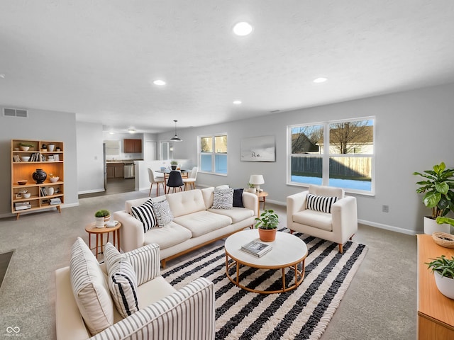 carpeted living room with a textured ceiling