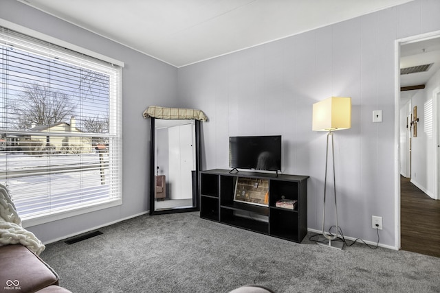 carpeted living room with baseboards and visible vents