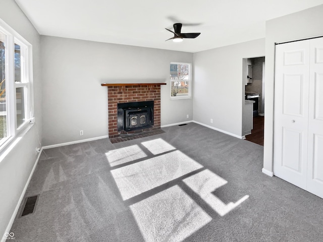 unfurnished living room with dark carpet and ceiling fan