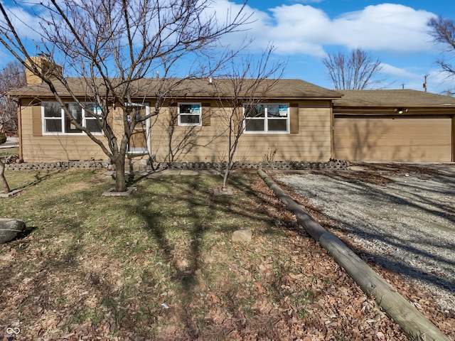 rear view of house with a yard and a garage