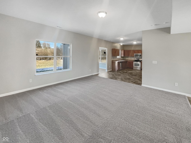 unfurnished living room with dark colored carpet