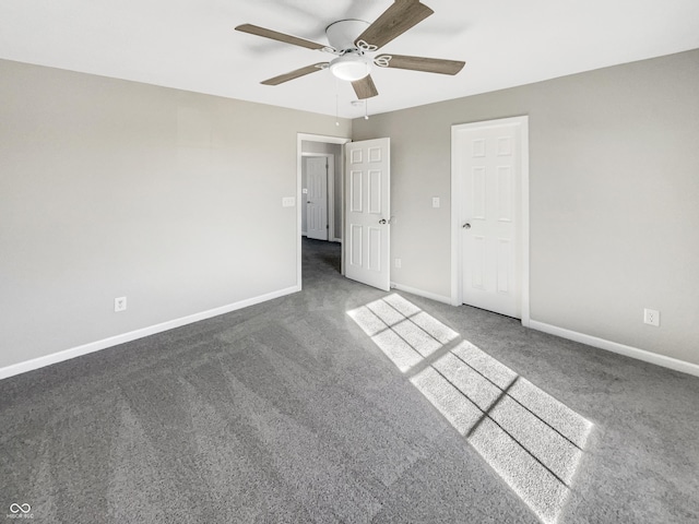 unfurnished bedroom with dark carpet and ceiling fan