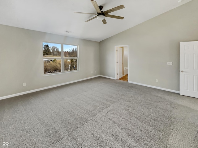 carpeted empty room with vaulted ceiling and ceiling fan