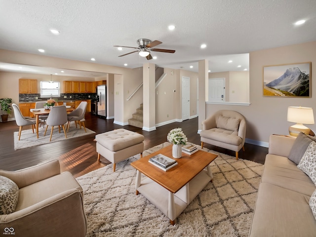 living room with light wood-type flooring and a textured ceiling