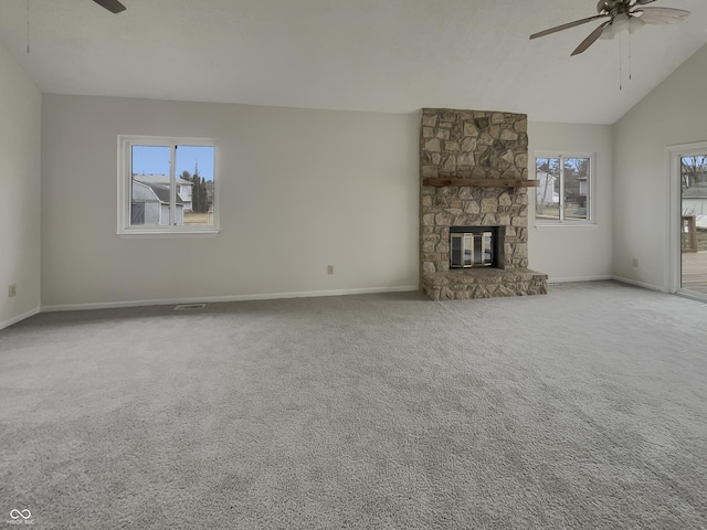 unfurnished living room featuring carpet flooring, a healthy amount of sunlight, ceiling fan, and a fireplace