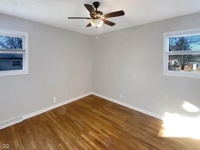 unfurnished room featuring ceiling fan, baseboards, and wood finished floors