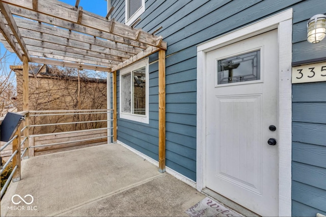 entrance to property with a pergola